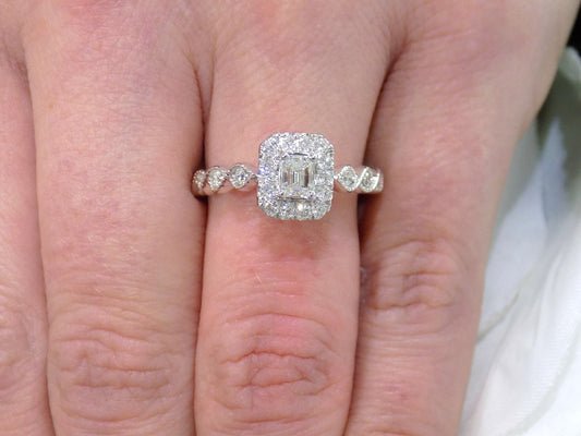 .75ct TW Halo Style Natural Emerald Cut Diamond Engagement Ring in Solid 14K White Gold with Rose Gold Accents on Side View with a Single Blue Sapphire