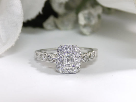 .75ct TW Halo Style Natural Emerald Cut Diamond Engagement Ring in Solid 14K White Gold with Rose Gold Accents on Side View with a Single Blue Sapphire