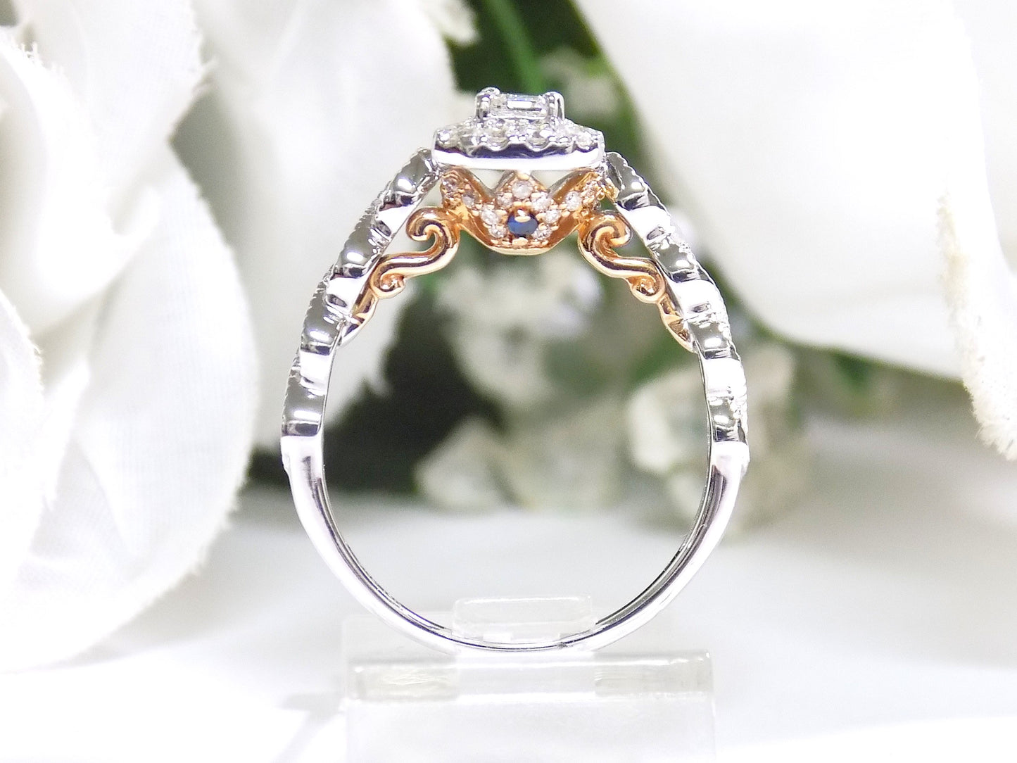 .75ct TW Halo Style Natural Emerald Cut Diamond Engagement Ring in Solid 14K White Gold with Rose Gold Accents on Side View with a Single Blue Sapphire