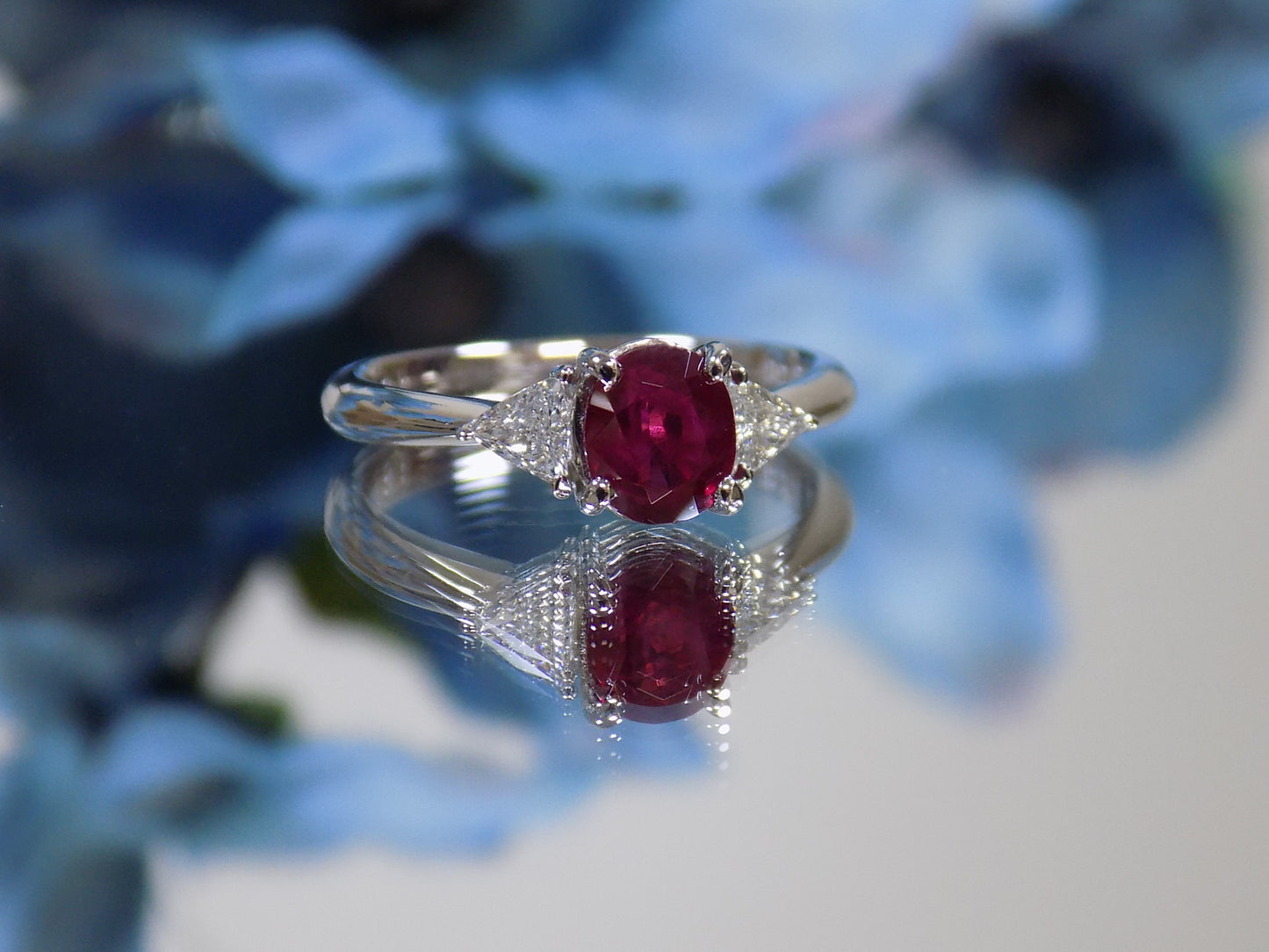 1.51ct Vintage Genuine High Quality Natural Pigeon Blood Oval Shape Ruby with a Natural Trillion Shape Diamond on Either Sider in Platinum